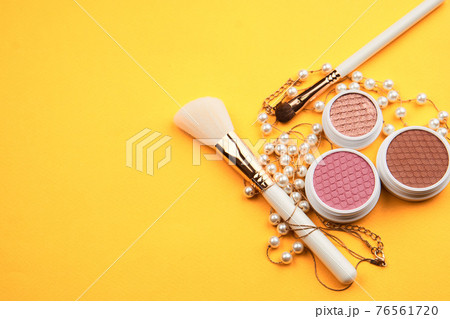Eyeshadow eye makeup brush on yellow background top view Copy Space 76561720