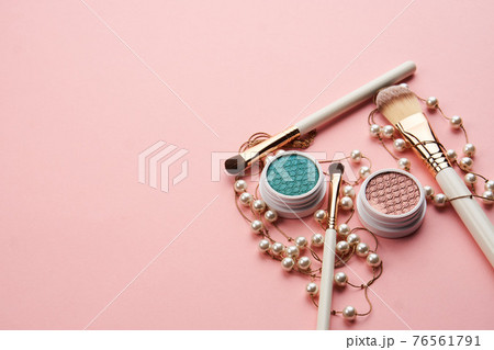 eyeshadow accessories beads makeup brushes collection professional cosmetics on pink background 76561791
