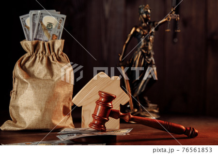 Bag of money, house and gavel with lady of justice. Real estate auction concept 76561853