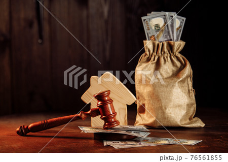 Money bag with cash house and judge gavel. Taxes on real estate, payment concept 76561855