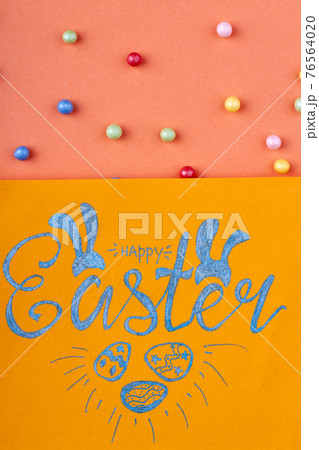 Happy easter handwriting. Yellow paper with happy easter wish. 76564020