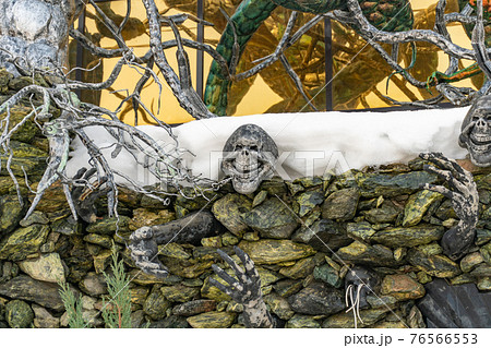 Decorative skeleton crawls out of a stone wall, house with skulls, house with devils in the village of Ratomka, a house with forged decorations Decorative skeleton crawls out of a stone wall, house with skulls, house with devils in the village of Ratomka, a house with forged decorations 76566553