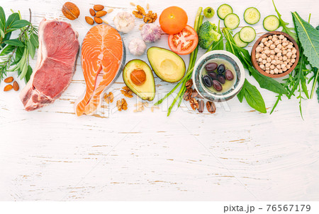 Ketogenic low carbs diet concept. Ingredients for healthy foods selection on white wooden background. Balanced healthy ingredients of unsaturated fats for the heart and blood vessels. Ketogenic low carbs diet concept. Ingredients for healthy foods selection on white wooden background. Balanced healthy ingredients of unsaturated fats for the heart and blood vessels. 76567179