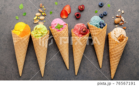 Various of ice cream flavor in cones blueberry ,strawberry ,pistachio ,almond ,orange and cherry setup on dark stone background . Summer and Sweet menu concept. Various of ice cream flavor in cones blueberry ,strawberry ,pistachio ,almond ,orange and cherry setup on dark stone background . Summer and Sweet menu concept. 76567191