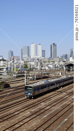 名古屋市の黄金跨線橋から見た、名古屋駅周辺の高層ビル群とあおなみ線の電車 76568021
