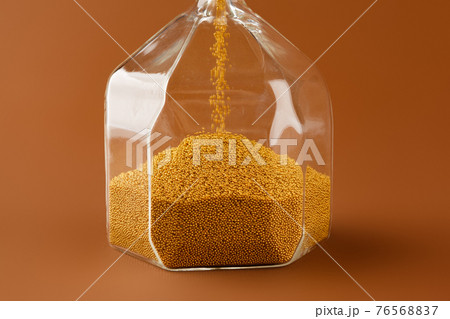 Close up of sandglass on paper background 76568837