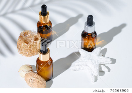 Skincare products containers on a white background with creative shadows Skincare products containers on a white background with creative shadows 76568906