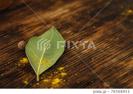 Bay leaves on wooden table close up 76568953