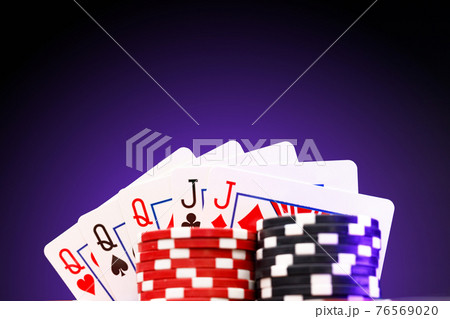 Poker chips and playing cards on black background Poker chips and playing cards on black background 76569020