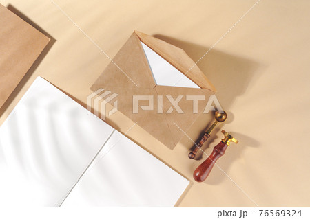 Craft paper letter on beige background top view Craft paper letter on beige background top view 76569324