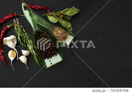 Red hot chili peppers and other spices on dark background Red hot chili peppers and other spices on dark background 76569706