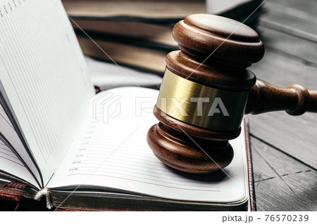 Judge's gavel on wooden table in dark 76570239