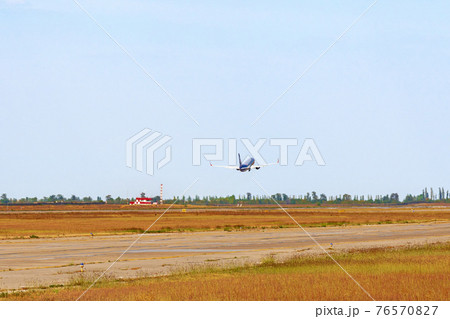 Passenger plane takes off from runway in airport 76570827