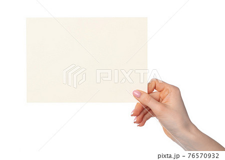 Woman's hand holding blank white sheet of paper isolated on white Woman's hand holding blank white sheet of paper isolated on white 76570932