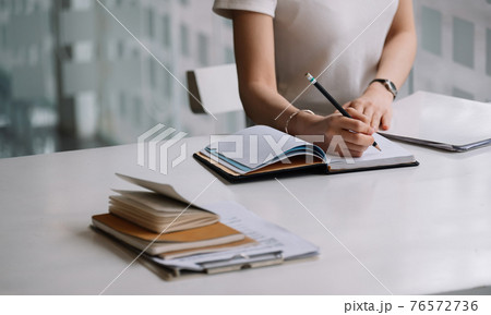 Close up of a woman writer hand writing in a notebook at home 76572736