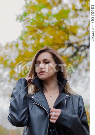 Beautiful woman portrait in forest in autumn. 76573481
