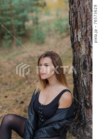 Beautiful woman portrait in forest in autumn. Beautiful woman portrait in forest in autumn. 76573629