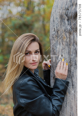 Beautiful woman portrait in forest in autumn. 76573708