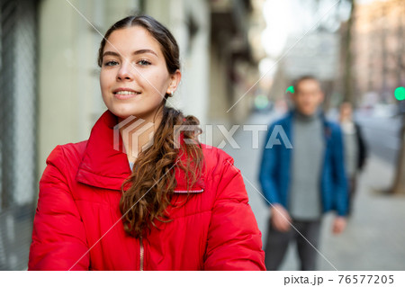 Positive smiling woman walking on the street 76577205