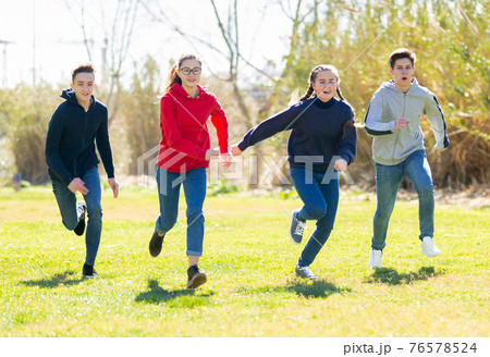 Teenagers are jogging together in the park and having fun Teenagers are jogging together in the park and having fun 76578524