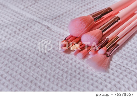 Wet make up brushes on towel, closeup 76578657