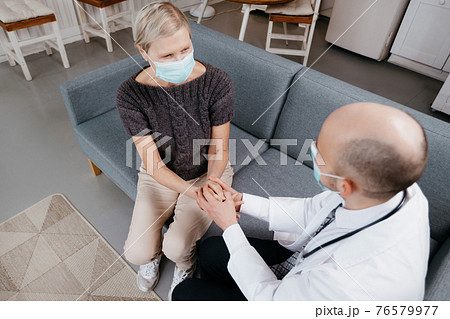 doctor calming an agitated patient during a home visit. doctor calming an agitated patient during a home visit. 76579977