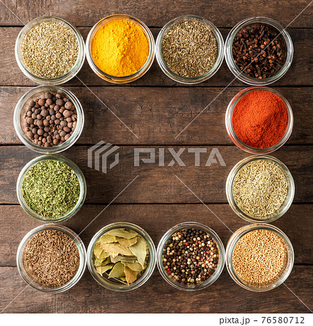Various types of seasonings in bowls. Collection of seasonings on wooden background with copyspace Various types of seasonings in bowls. Collection of seasonings on wooden background with copyspace 76580712