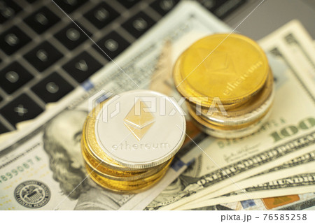 Ethereum coins on a dollars and on a laptop. Trading on the cryptocurrency exchange. Cryptocurrency Stock Market Concept. Mining or blockchain technology. Business concept. Ethereum coins on a dollars and on a laptop. Trading on the cryptocurrency exchange. Cryptocurrency Stock Market Concept. Mining or blockchain technology. Business concept. 76585258