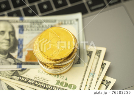 Ethereum coins on a dollars and on a laptop. Trading on the cryptocurrency exchange. Cryptocurrency Stock Market Concept. Mining or blockchain technology. Business concept. Ethereum coins on a dollars and on a laptop. Trading on the cryptocurrency exchange. Cryptocurrency Stock Market Concept. Mining or blockchain technology. Business concept. 76585259