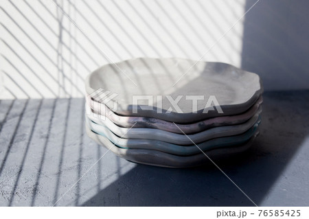 Pile set of Stone curl color platter on gray conrete table 76585425
