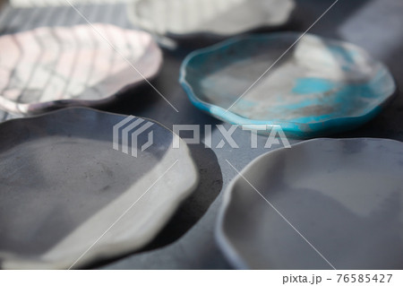 Pile set of Stone curl color platter on gray conrete table Pile set of Stone curl color platter on gray conrete table 76585427