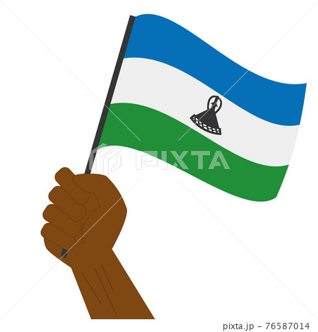 Hand holding and raising the national flag of Lesotho Hand holding and raising the national flag of Lesotho 76587014