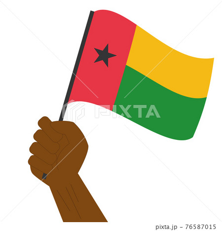 Hand holding and raising the national flag of Guinea Bissau Hand holding and raising the national flag of Guinea Bissau 76587015