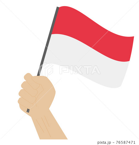 Hand holding and raising the national flag of Indonesia 76587471