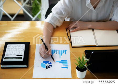 Close up Business woman hand holding pencil and financial paperwork with financial network diagram. 76588025