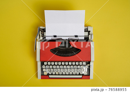 Top view of red vintage typewriter with white blank paper sheet Top view of red vintage typewriter with white blank paper sheet 76588955