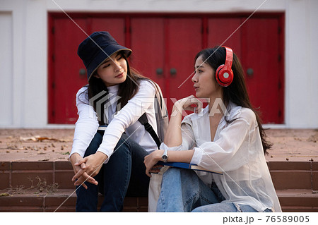 Asian woman traveler with backpack talking about history this place and sitting in stair, travel holiday relaxation concept. Asian woman traveler with backpack talking about history this place and sitting in stair, travel holiday relaxation concept. 76589005