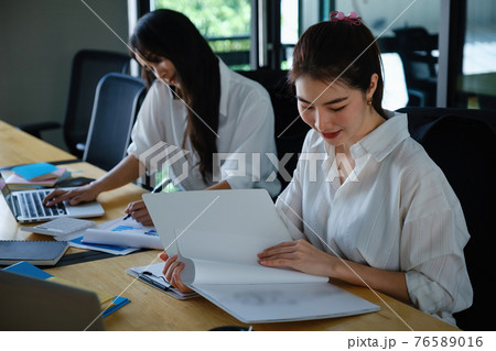 Two of Young business female working together and partners talking with customer. 76589016