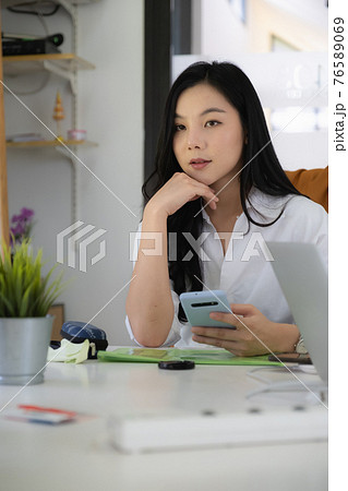 Portrait of Asian Business woman working from home. Accounting concept. Portrait of Asian Business woman working from home. Accounting concept. 76589069