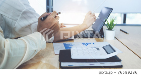 Fund managers team consultation and discuss about analysis Investment stock market by digital tablet. 76589236