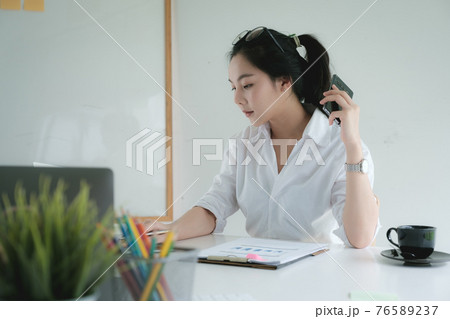 Portrait of Asian Business woman working from home. Accounting concept. 76589237