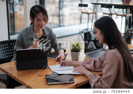 Business woman and partners in smart casual wear discussing business while sitting in the home office. Confident and successful team. 76589444
