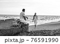 loving couple on seaside in white dress 76591990