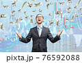 businessman trader winner, in cash rain of dollars notes 76592088