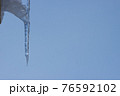 Icicle icy against the blue sky. 76592102