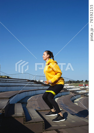 young woman doing sports outdoors by the sea 76592155