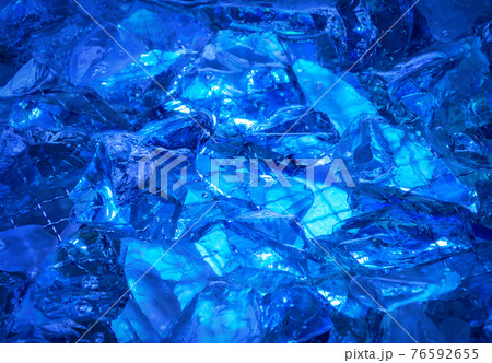 Ultramarine background of shiny-crystal stones lit mysterious gloww 76592655