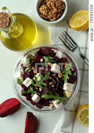 Concept of tasty eating with beet salad on white textured background 76593506