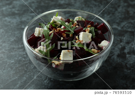 Bowl with fresh beet salad on black smoky background 76593510