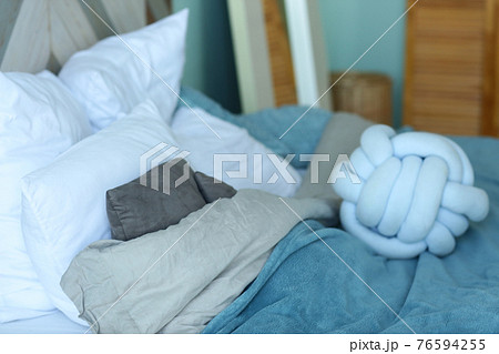 cute modern bedroom corner blue bad, pillows, duvet closeup photo cute modern bedroom corner blue bad, pillows, duvet closeup photo 76594255